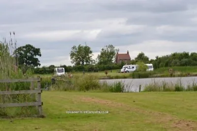 View across the fishing lake to touring pitches at Wagtail Park, York